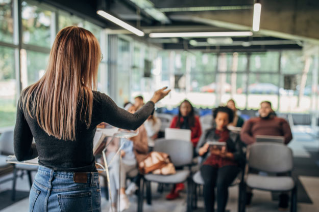 A photo of a women presenting to an audience
