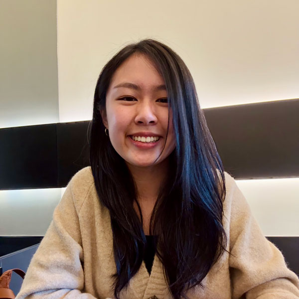 A photo of Samantha Fung smiling at a cafe